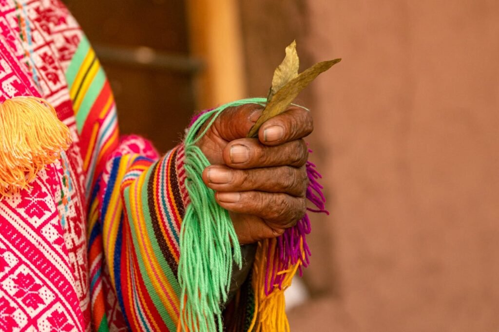 pexels-photo-27173604 Woman Hand in Traditional Clothing Holding Leaves